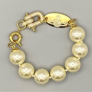 Vivienne Westwood large faux pearl bracelet with encrusted lock in gold tone